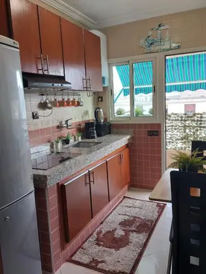 a kitchen with a sink and a refrigerator at Appartement avec terrasse au cœur du centre-ville de Rabat in Rabat