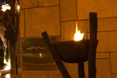 a fire burning in a candle holder on a brick wall at Villa Des Ambassadors in Rabat