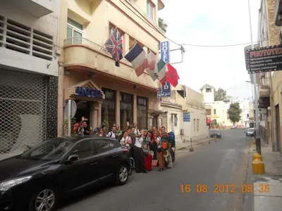 a group of people standing outside of a building at Hôtel Astrid in Casablanca