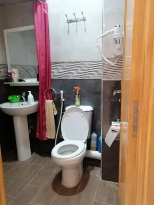 a small bathroom with a toilet and a sink at Joli appartement Casablanca ain sebaa in Casablanca