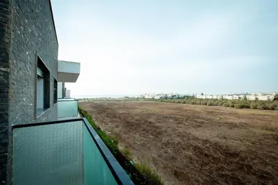 a balcony with a view of a field at Garden Bay Appart'Hôtel in Casablanca