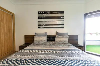 a bedroom with a large bed in a room at Miramar Residence Beach in Mohammedia