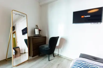 a bedroom with a mirror and a chair and a dresser at Miramar Residence Beach in Mohammedia