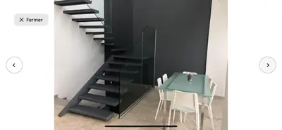 a glass staircase with a table and a dining room at Villa moderne avec piscine, front de mer in Casablanca