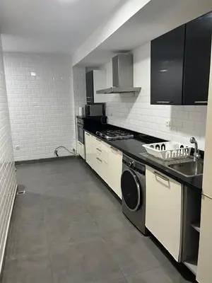 a kitchen with a stove and a washer and dryer at Villa moderne avec piscine, front de mer in Casablanca