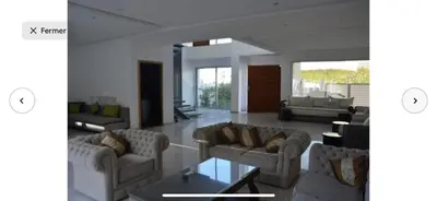 a living room with two couches and a table at Villa moderne avec piscine, front de mer in Casablanca