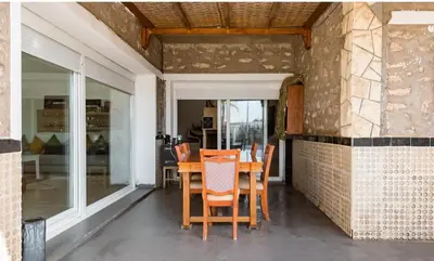 a dining room with a table and chairs at Elaaz Horse Farm in Azemmour