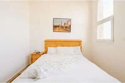 a bedroom with a white bed and a window at Elaaz Horse Farm in Azemmour