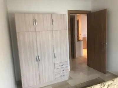 a large wooden cabinet in a room with a mirror at Champs Elysee in Casablanca