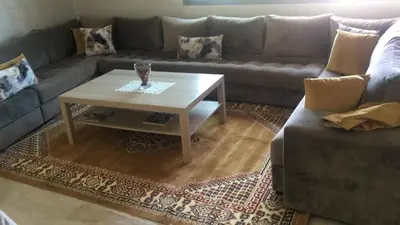 a living room with a couch and a coffee table at Champs Elysee in Casablanca