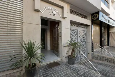 a store front with two plants in front of it at Champs Elysee in Casablanca