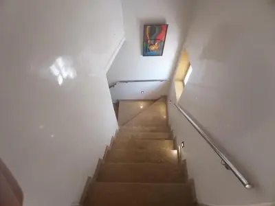 a staircase in a building with a painting on the wall at Ryad 91 in Casablanca