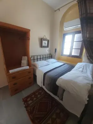 a bedroom with two beds and a window at Ryad 91 in Casablanca