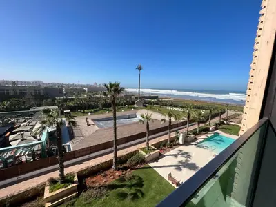 a view of the beach from the balcony of a resort at Pestana Casablanca, Seaside Suites & Residences in Casablanca
