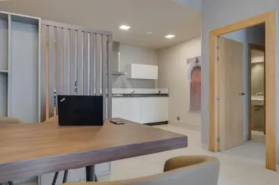 a dining room with a wooden table and chairs at Pestana Casablanca, Seaside Suites & Residences in Casablanca