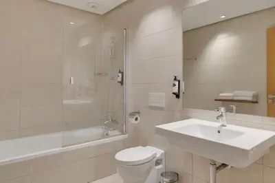 a bathroom with a sink and a toilet and a shower at Pestana Casablanca, Seaside Suites & Residences in Casablanca