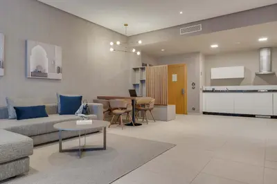 a living room with a couch and a table at Pestana Casablanca, Seaside Suites & Residences in Casablanca