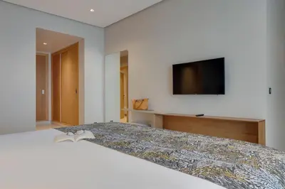 a bedroom with a bed with a book on it at Pestana Casablanca, Seaside Suites & Residences in Casablanca
