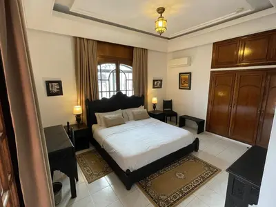 a bedroom with a large bed and a window at Dar Tahra in Casablanca