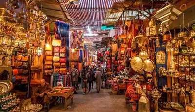a group of people walking through a shop in a market at le spatieux in Casablanca