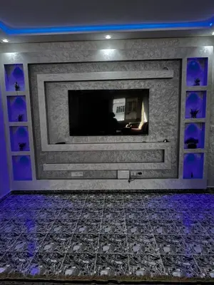 a living room with a fireplace with purple lights at le spatieux in Casablanca