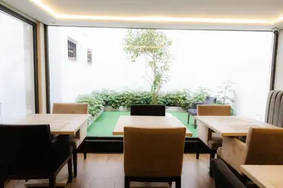 a restaurant with tables and chairs and a large window at WINDSOR HOTEL CITY CENTER in Casablanca