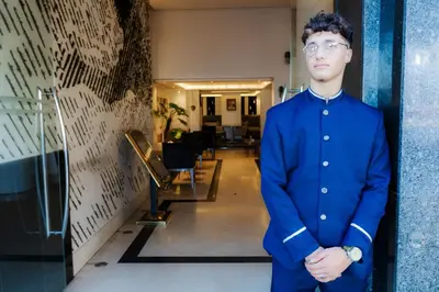 a man in a blue suit standing in a hallway at WINDSOR HOTEL CITY CENTER in Casablanca