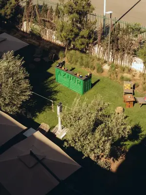 a large green sign in the middle of a yard at ONOMO Airport Casablanca in Casablanca