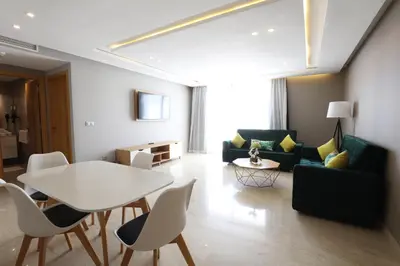 a living room with a white table and chairs at Mid Town Hotel Casablanca in Casablanca