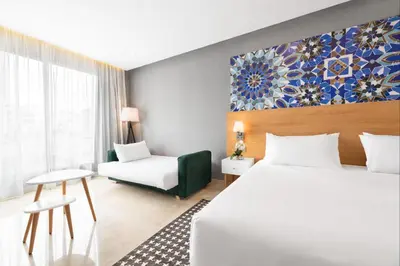 a hotel room with a bed and a couch at Mid Town Hotel Casablanca in Casablanca