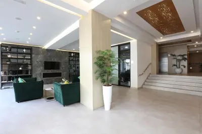 a lobby with couches and a plant in a building at Mid Town Hotel Casablanca in Casablanca