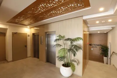 a lobby with a palm tree in a pot at Mid Town Hotel Casablanca in Casablanca