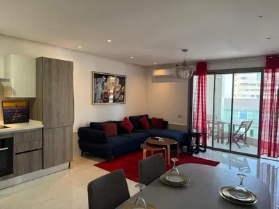 a living room with a couch and a table at Belle-Vue sur Mer à Casa-Marina 9éme étage in Casablanca