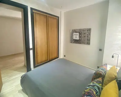 a living room with a couch and a wooden door at Superbe appartement très bien situé WELCOME STAY in Casablanca