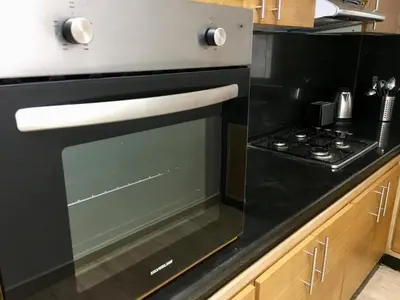 a black and white oven in a kitchen at Superbe appartement très bien situé WELCOME STAY in Casablanca