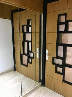 a room with a glass door with a wall at Superbe appartement très bien situé WELCOME STAY in Casablanca