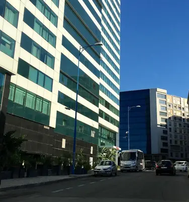 a city street with cars parked in front of a building at Superbe appartement très bien situé WELCOME STAY in Casablanca