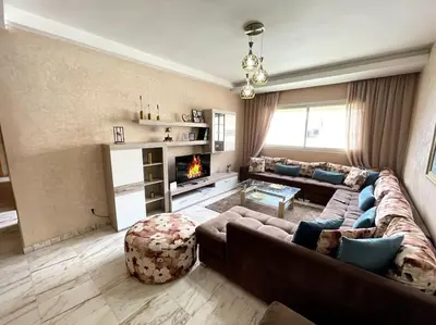 a living room with a couch and a fireplace at Late&Early Flight cozy Apartment in Nouaseur