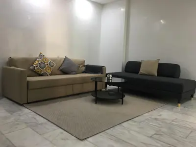 a living room with a couch and a table at Appartement Miramar in Mohammedia