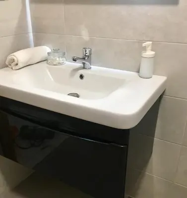 a white sink in a bathroom next to a wall at Appartement Miramar in Mohammedia