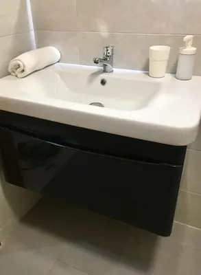 a bathroom sink with two cups on top of it at Appartement Miramar in Mohammedia