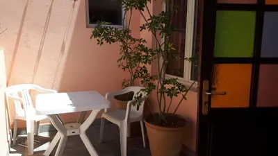 a table and two chairs and a table and a plant at Faridi vacancy appartment in Casablanca