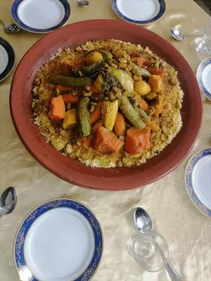 a bowl of food on a table with a plate of food at Faridi vacancy appartment in Casablanca