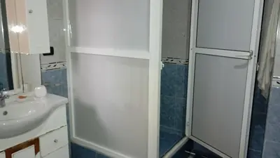 a bathroom with a sink and a white refrigerator at Faridi vacancy appartment in Casablanca