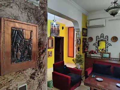 a living room with yellow and orange walls at Appartement a casablanca in Casablanca