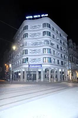 a white building with a sign on top at night at HOTEL DELTA ATLAS in Casablanca