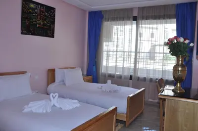 a hotel room with two beds and a window at HOTEL DELTA ATLAS in Casablanca