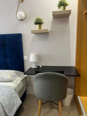 a bedroom with a desk and a chair and a bed at Hadil Room in Rabat