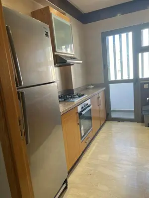 a kitchen with a stainless steel refrigerator and a stove at Hadil Room in Rabat