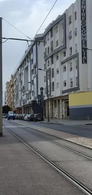 an empty street with cars parked in front of buildings at Hadil Room in Rabat